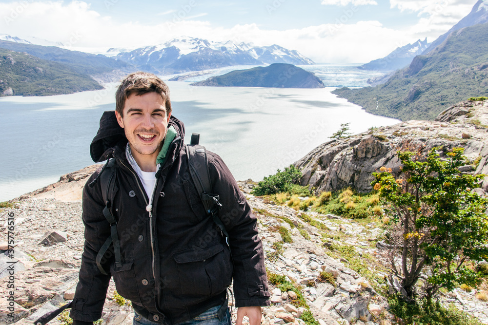 Young happy man portrait on glacier and mountain landscape in Patagonia Young happy man portrait on glacier and mountain landscape in Patagonia