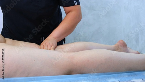 anti-cellulite foot massage for a fat woman. the concept of personal care, body care, weight loss, diet. close-up