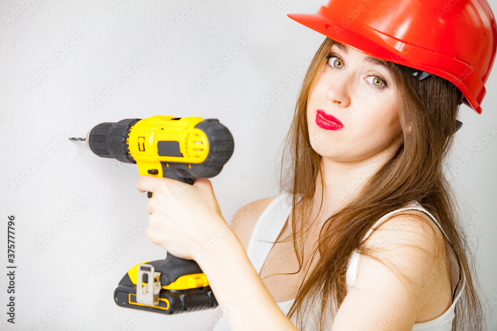 Woman using power driil for work at home Woman using power driil for work at home