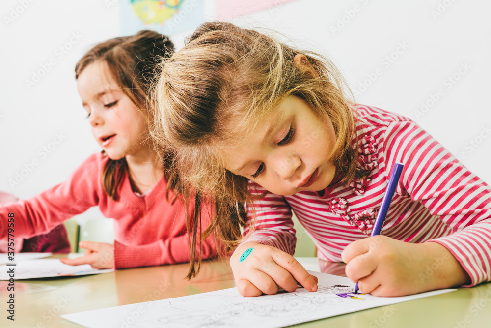 Little Adorable Girls Drawing at School Little Adorable Girls Drawing at School