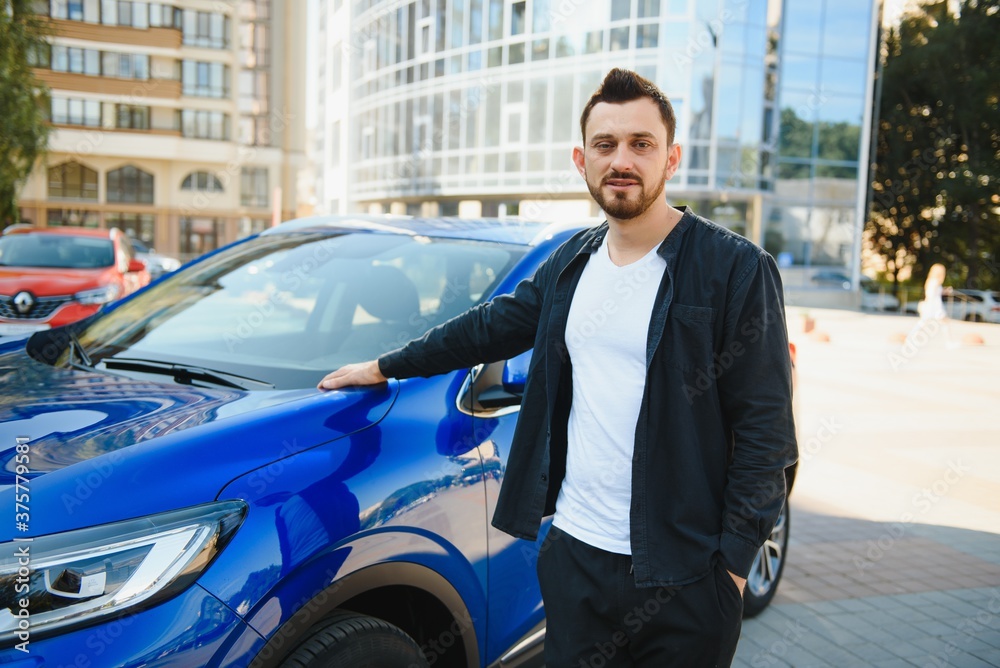 successful man near his car