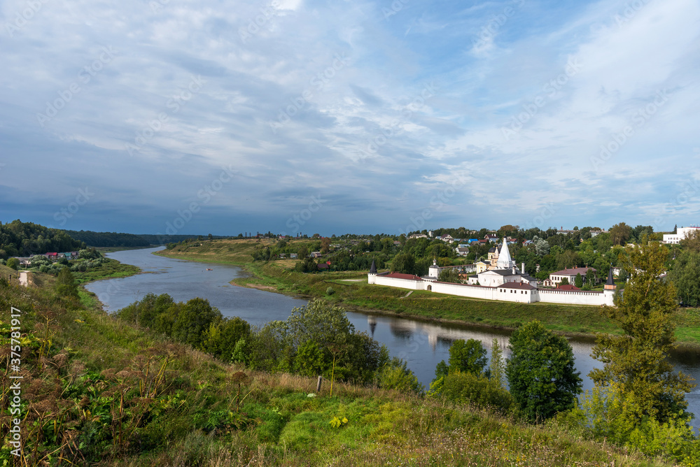 Picturesque view of small ancient town Staritsa with Staritskiy Holy Dormition Monastery on the Volga River in Russia. Picturesque view of small ancient town Staritsa with Staritskiy Holy Dormition Monastery on the Volga River in Russia.