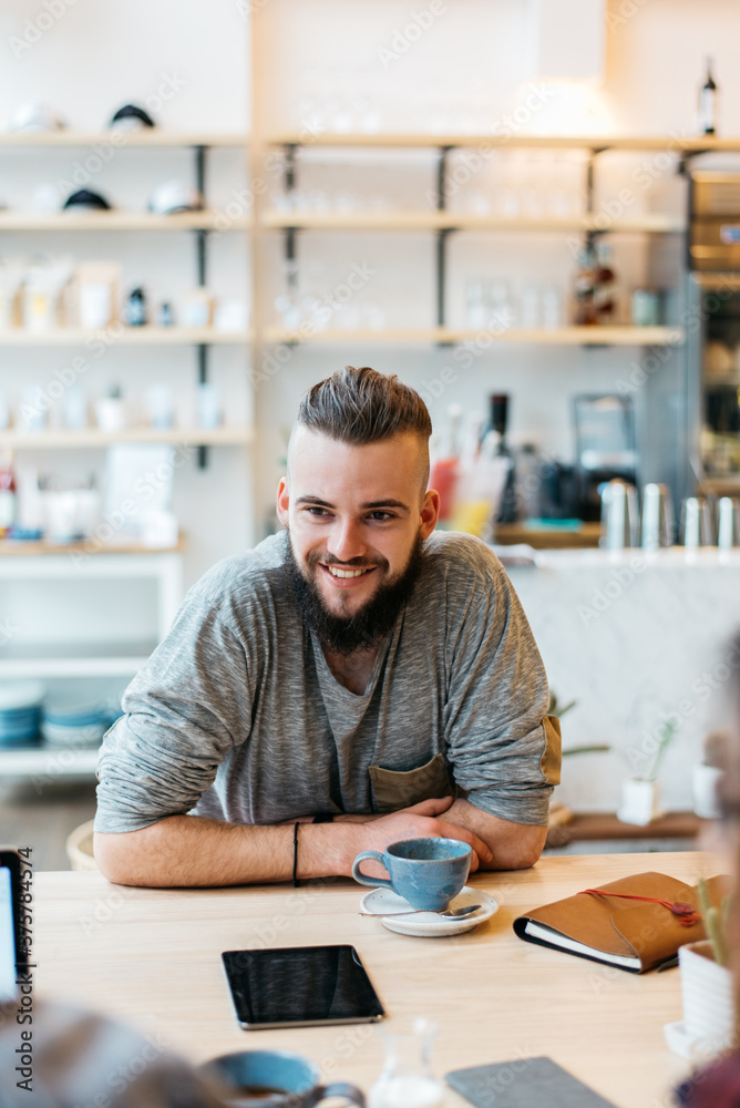 Smiling Young Man Sitting At The Coffee Shop Smiling Young Man Sitting At The Coffee Shop