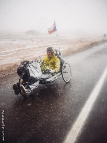 Handbiker covered in snow standing on the road photo