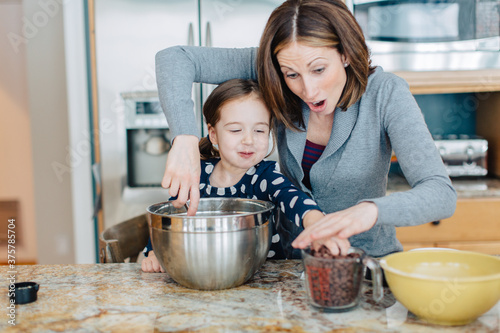 Mother showing daughter how to make chocolate chip cookies