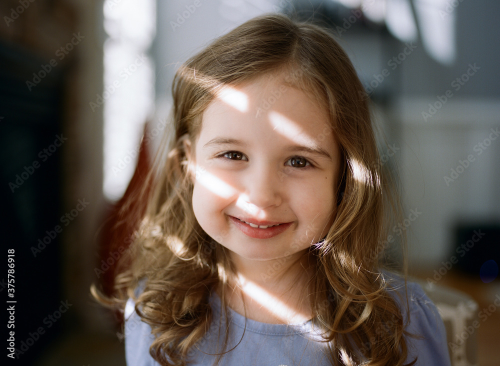 Portrait of a cute toddler with light strips across her face Portrait of a cute toddler with light strips across her face
