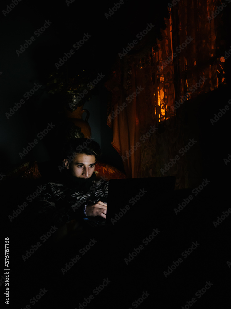 Arab man using his laptop at night Arab man using his laptop at night