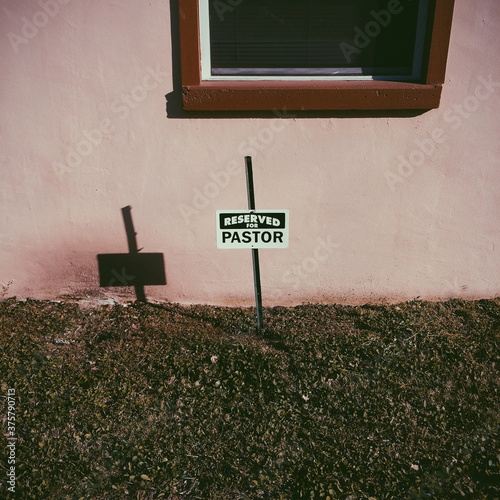 Parking sign at a church that reads 