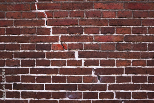 Old brick wall with a crack in the middle photo