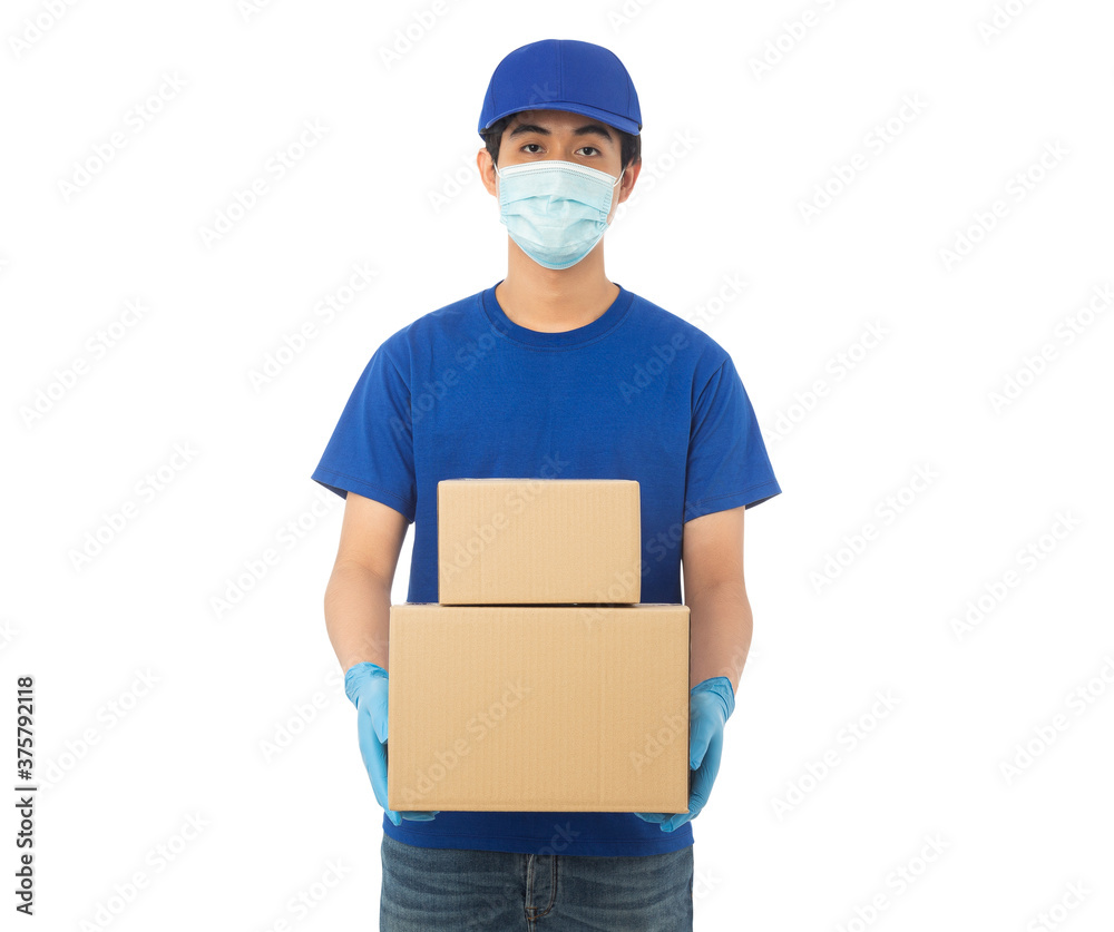 Young Delivery man wearing mask and medical gloves holding paper cardboard box mockup isolated on white background with clipping path. Young Delivery man wearing mask and medical gloves holding paper cardboard box mockup isolated on white background with clipping path.