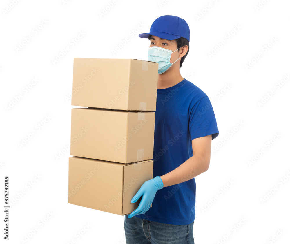 Young Delivery man wearing mask and medical gloves holding paper cardboard box mockup isolated on white background with clipping path. Young Delivery man wearing mask and medical gloves holding paper cardboard box mockup isolated on white background with clipping path.