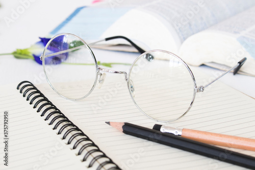 notebook memo ,dictionary book and spectacle of student for study arrangement flat lay style on background white 