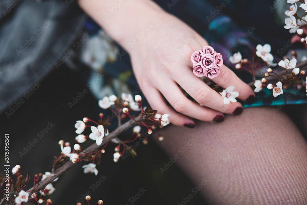 Girl holding cherry blossom twig in her hands Girl holding cherry blossom twig in her hands