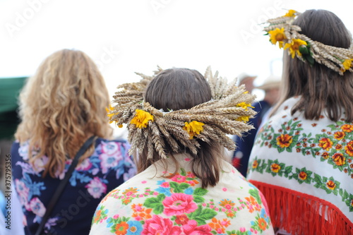 Traditional wheat harvesting in eastern Poland (Lesniowice, village Lublin voivodship) in old clothes with scythe in summer photo