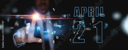 april 21st. Day 20 of month,advertising or high-tech calendar, man in suit presses bright virtual button spring month, day of the year concept