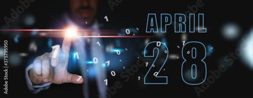 april 28th. Day 28 of month,advertising or high-tech calendar, man in suit presses bright virtual button spring month, day of the year concept