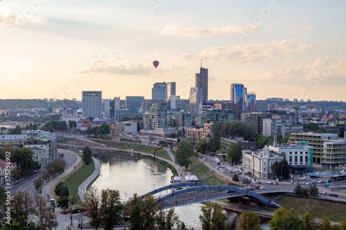 anorama of Vilnius at sunset in August 2020. City buildings. Skyscrapers on the horizon. Blue sky over the city. Clouds and sun at sunset. Summer evening. A quiet day at the weekend