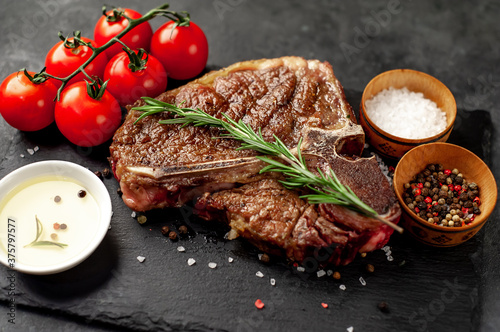 Vászonkép grill t-bone steak with on stone background