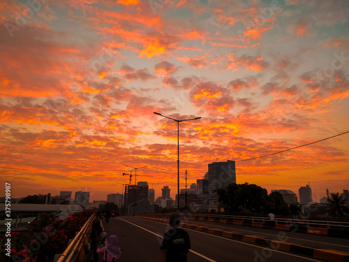sunrise over the city. I took this picture Sunday morning on a flyover on my way to cycling, Jakarta, Indonesia