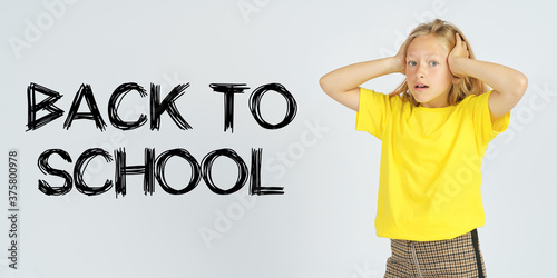 A teenager girl holding her head in surprise. Isolated background. The text is written next to it - BACK TO SCHOOL