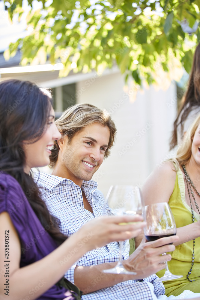 Group of friends enjoying drinks at outdoor lounge