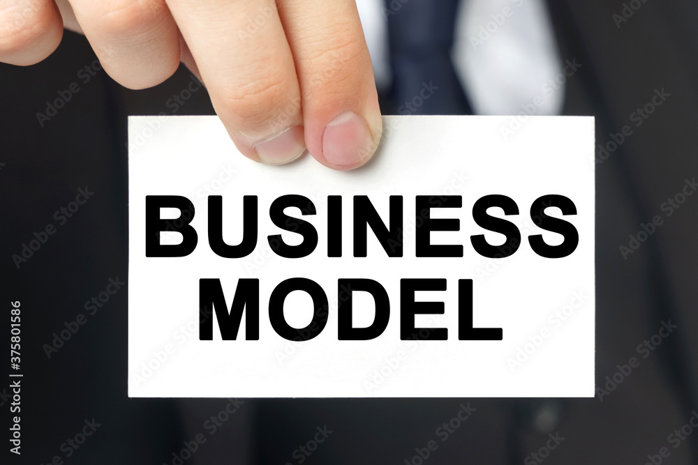 Businessman shows a card with the text - BUSINESS MODEL Businessman shows a card with the text - BUSINESS MODEL