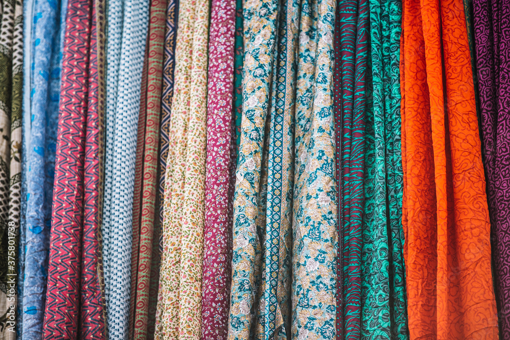 Texture and detail of colourful clothes - fabric hanging Texture and detail of colourful clothes - fabric hanging