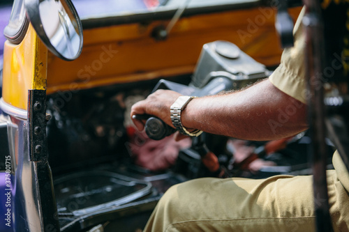 Detail of the hand and arm of an autorickshaw driver in India photo