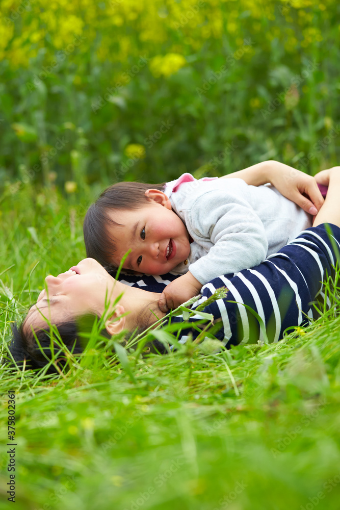 happy little girl playing with her mother outdoor in spring field happy little girl playing with her mother outdoor in spring field