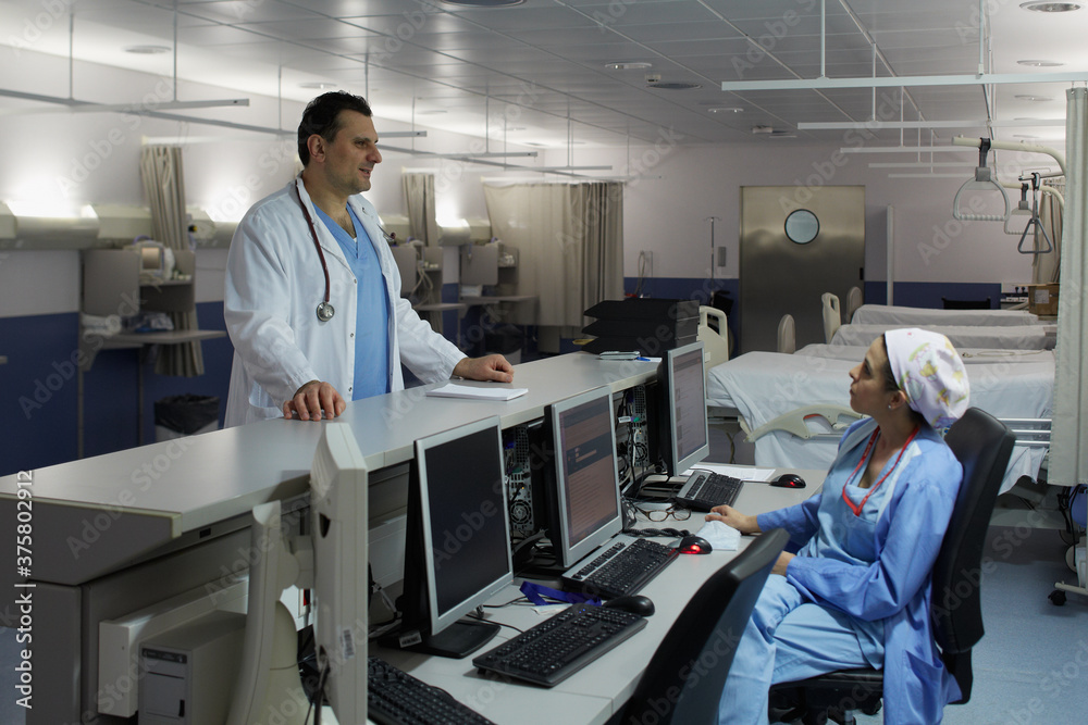 Two medical professionals talking in the recovery room Two medical professionals talking in the recovery room