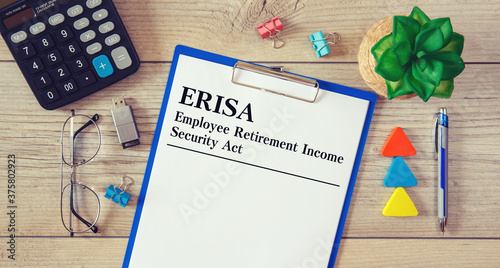Paper with ERISA - Employee Retirement Income Security Act on the table