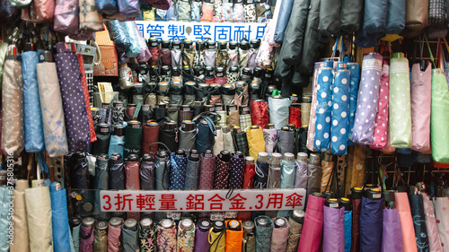 Various colorful folding umbrellas being sold at a street store in Taiwan photo