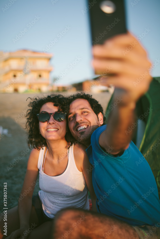Happy couple taking selfie photo on the beach Happy couple taking selfie photo on the beach