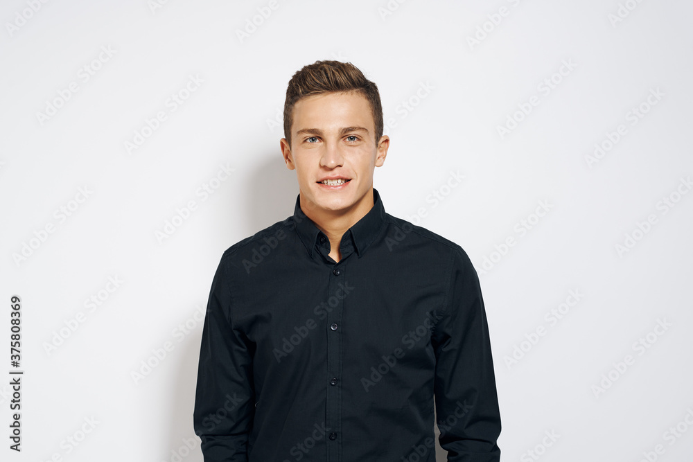 Man in black shirt lifestyle emotions modern style cropped view light background Man in black shirt lifestyle emotions modern style cropped view light background