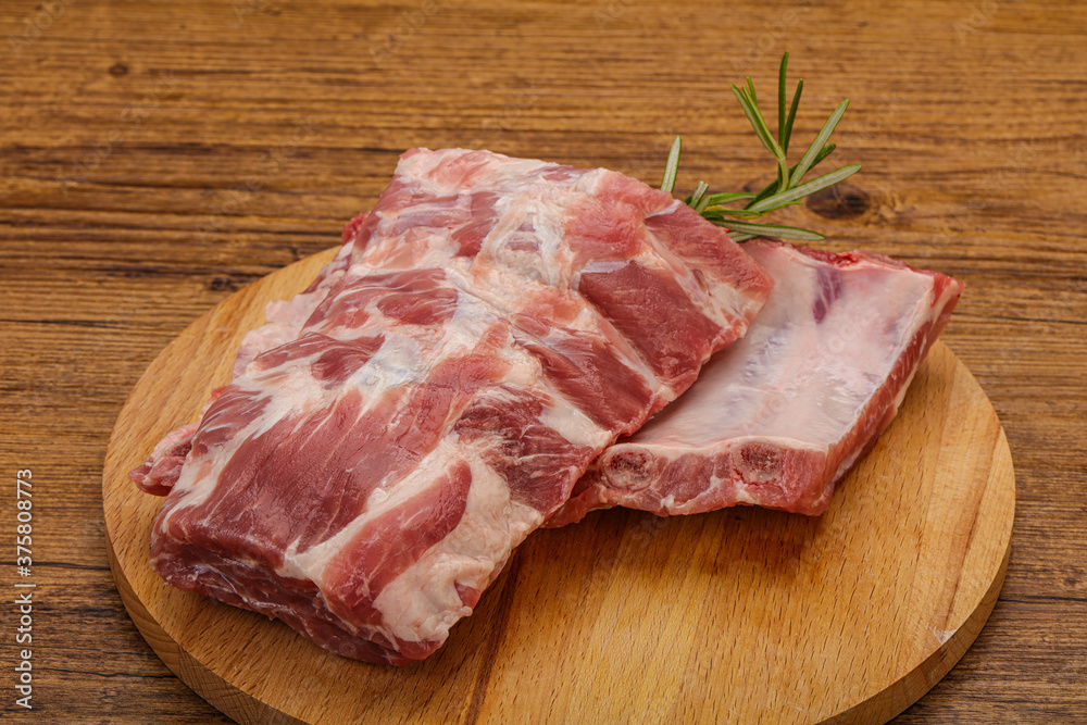 Raw pork ribs served rosemary