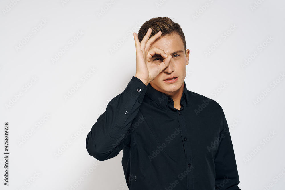 Man in black shirt lifestyle emotions modern style cropped view light background Man in black shirt lifestyle emotions modern style cropped view light background