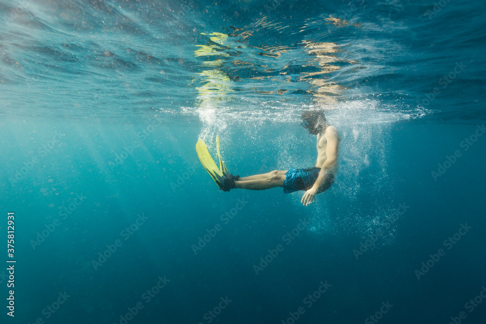 Man having fun while snorkeling in the ocean Man having fun while snorkeling in the ocean