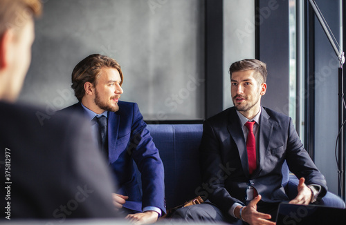 Businessmen Having a Chat at a CafÕ© photo