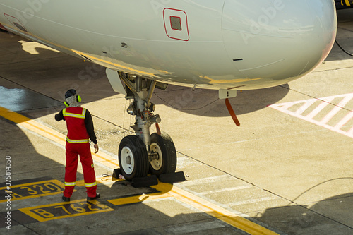 Airplane in the airport serviced by the ground crew before departure at Donmueang International Airport, Thailand.