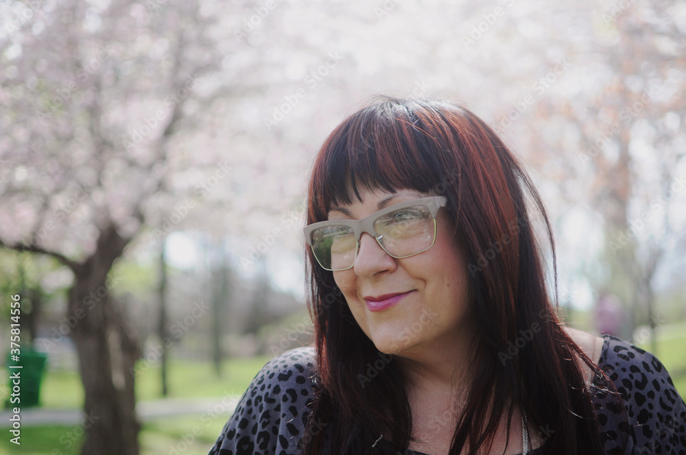 A fifty something woman wearing glasses and smiling A fifty something woman wearing glasses and smiling