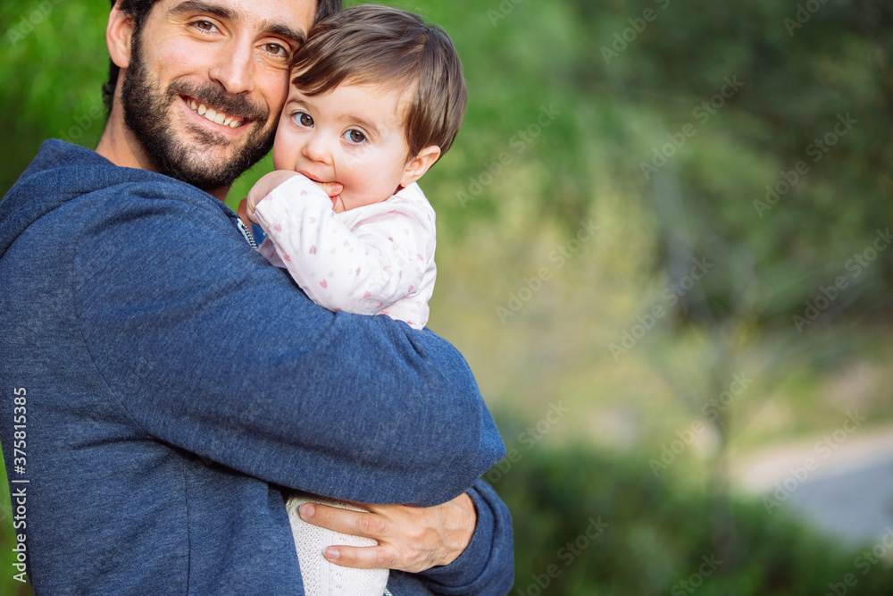 Young man father with his baby girl daughter in his arms Young man father with his baby girl daughter in his arms