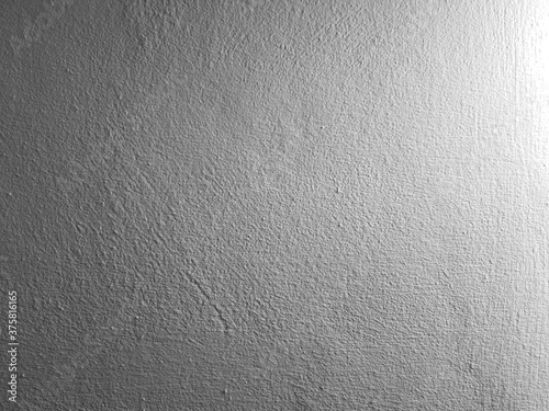 Grey concrete wall background with texture and natural light.