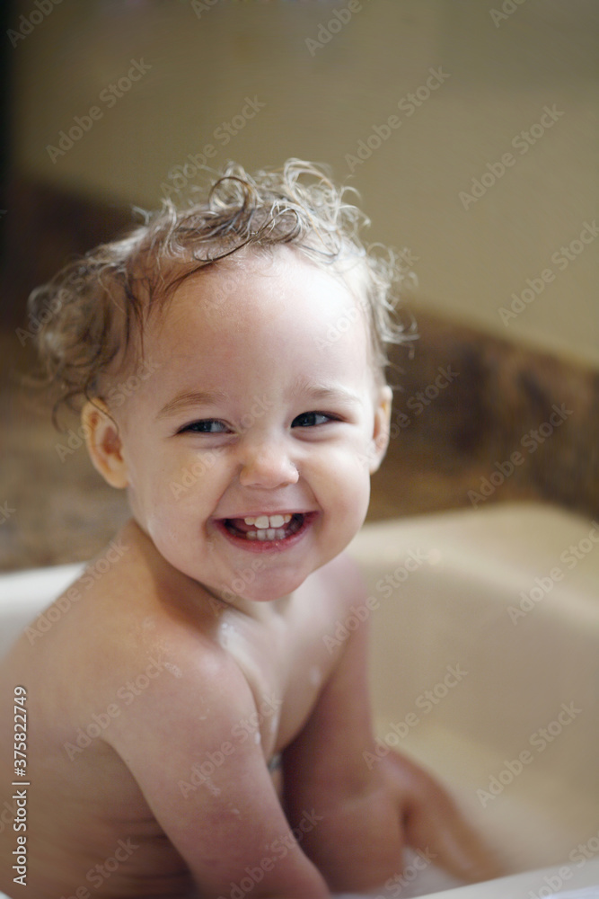 Giggly Curly Haired Baby Sitting In Sink Bath tub Giggly Curly Haired Baby Sitting In Sink Bath tub