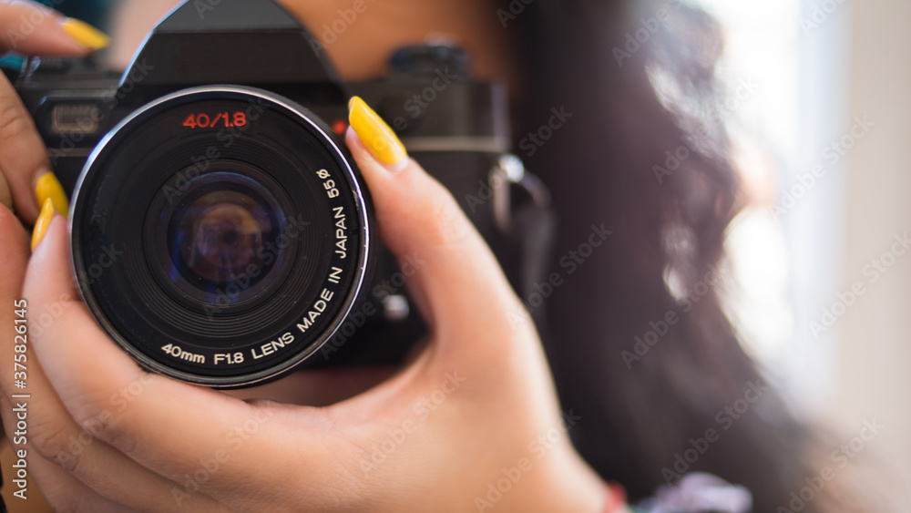 WOMAN FOCUSING WITH CAMERA