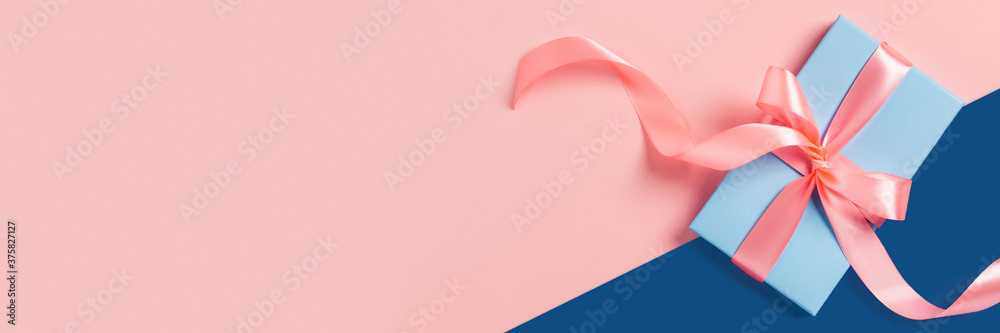 Greeting web banner with blue gift box. Pink bows. Space for your text. - obrazy, fototapety, plakaty 