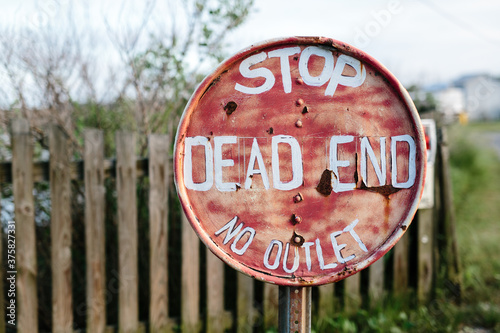 No outlet dead end stop sign on post at end of road photo