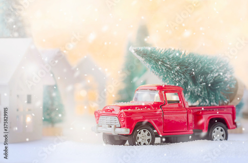 red car carrying a christmas tree. christmas card