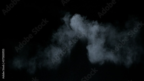 Misty chalk clouds blowing into center. Isolated white smoke and fog wisp on black background. Studio concept and VFX plate shot for scene overlay cut out template and creative enhancement.