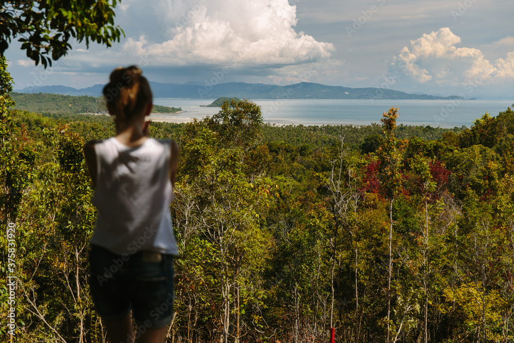 Woman looking at the approaching clouds Woman looking at the approaching clouds