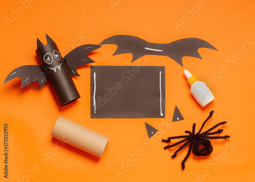 Diy Halloween bat from toilet tube on orange background. Halloween holiday concept. Instruction.Step by step.Top view. Children Halloween craft. Workshop.Step 3